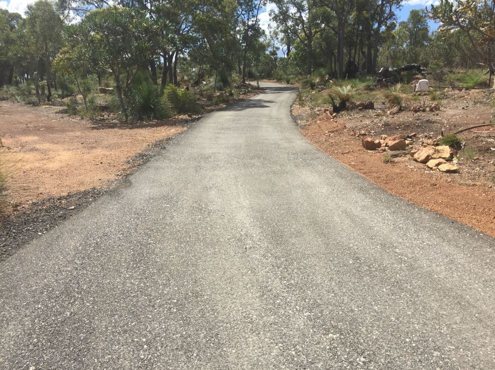 This is a photo of a hot spray & seal bitumen driveway which is in the process of being installed by Sunshine Road Tech