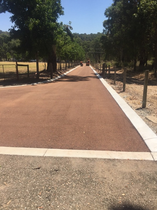 This is a photo of a hot spray & seal bitumen roadway which is in the process of being installed by Sunshine Road Tech